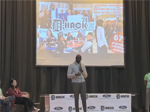 Guest speaker on stage at D-Hack